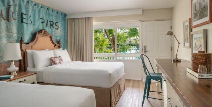 View of two queen beds in a Havana Cabana hotel room.