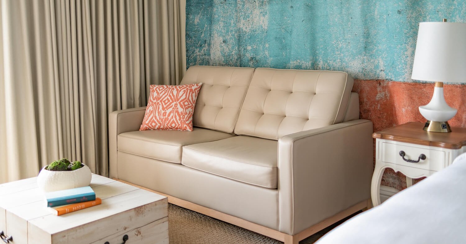 A Key West hotel room equipped with a beige couch