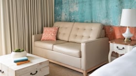 A Key West hotel room equipped with a beige couch