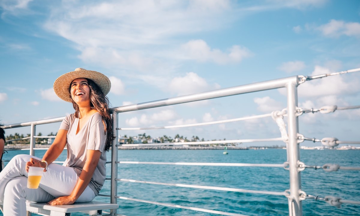 a woman on a cruise with a drink