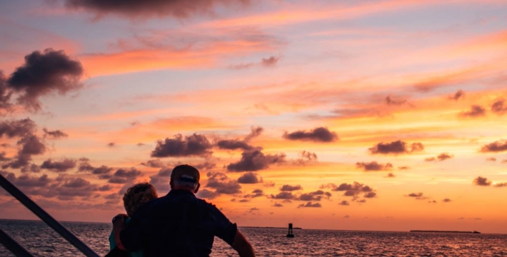 an older couple watching the sunset