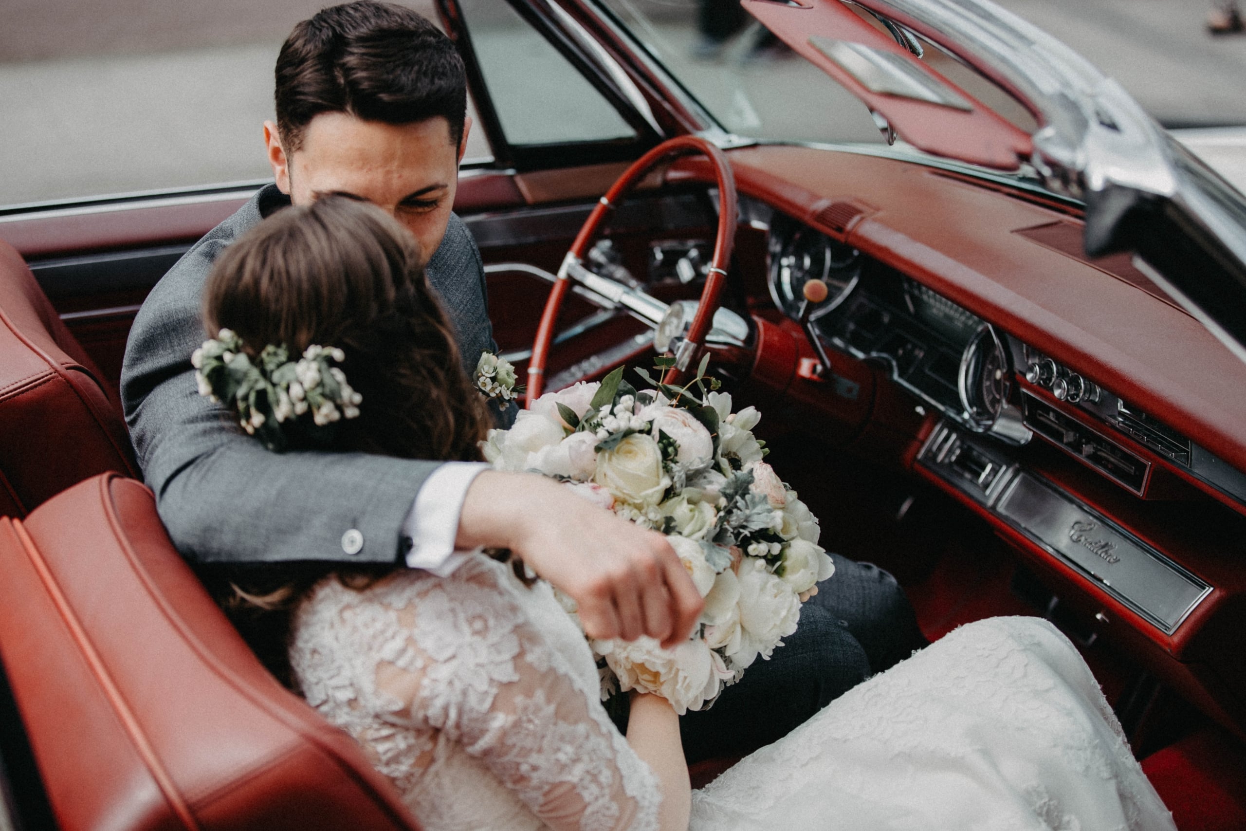 a wedding couple in a classic car