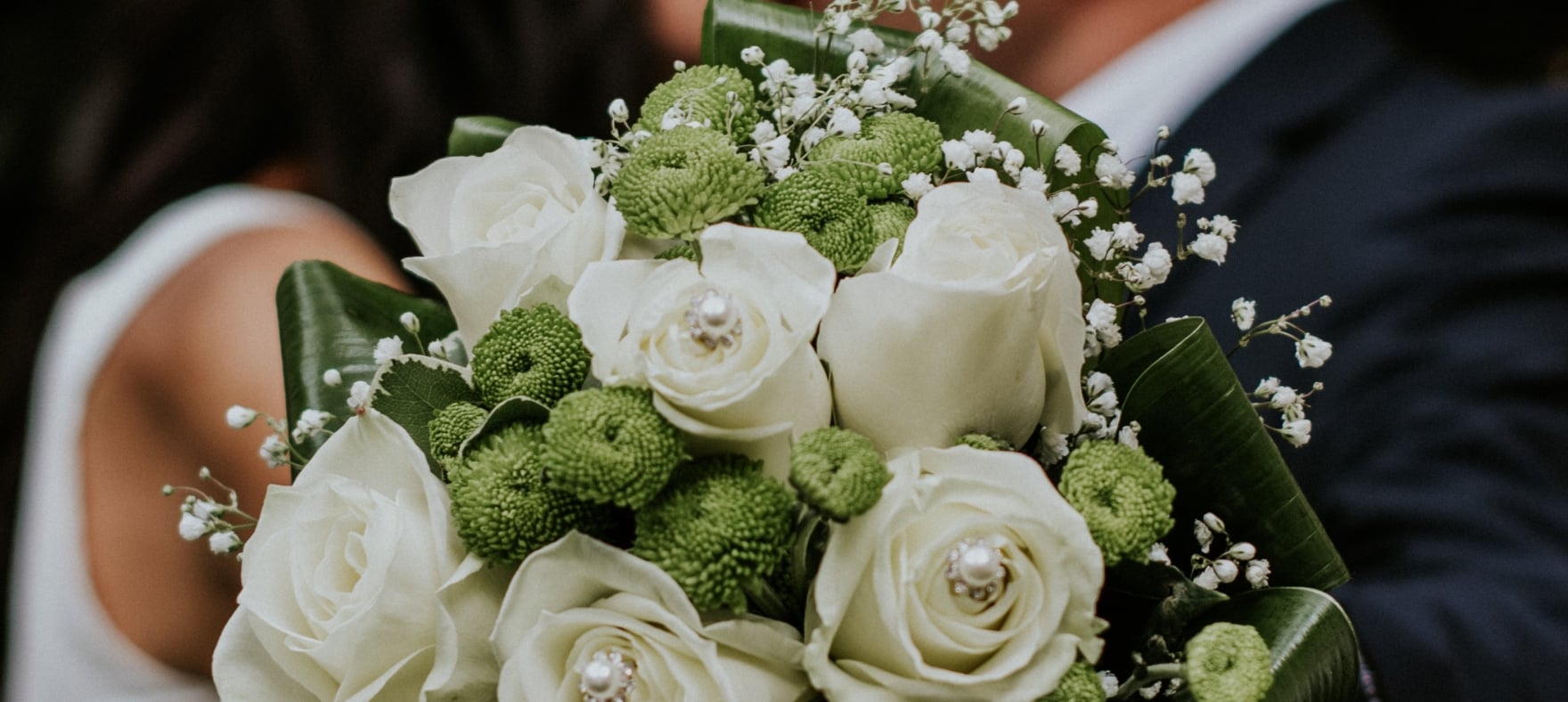 a couple kissing with flowers in their hands