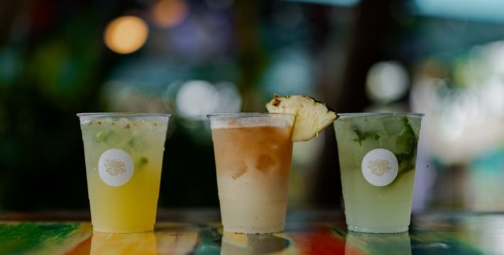 Three tropical cocktails on a colorful bar at Havana Cabana Key West