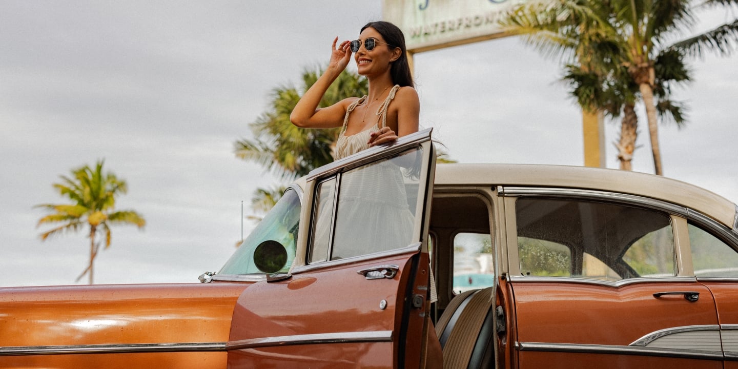 Guest standing beside vintage Havana Cabana car